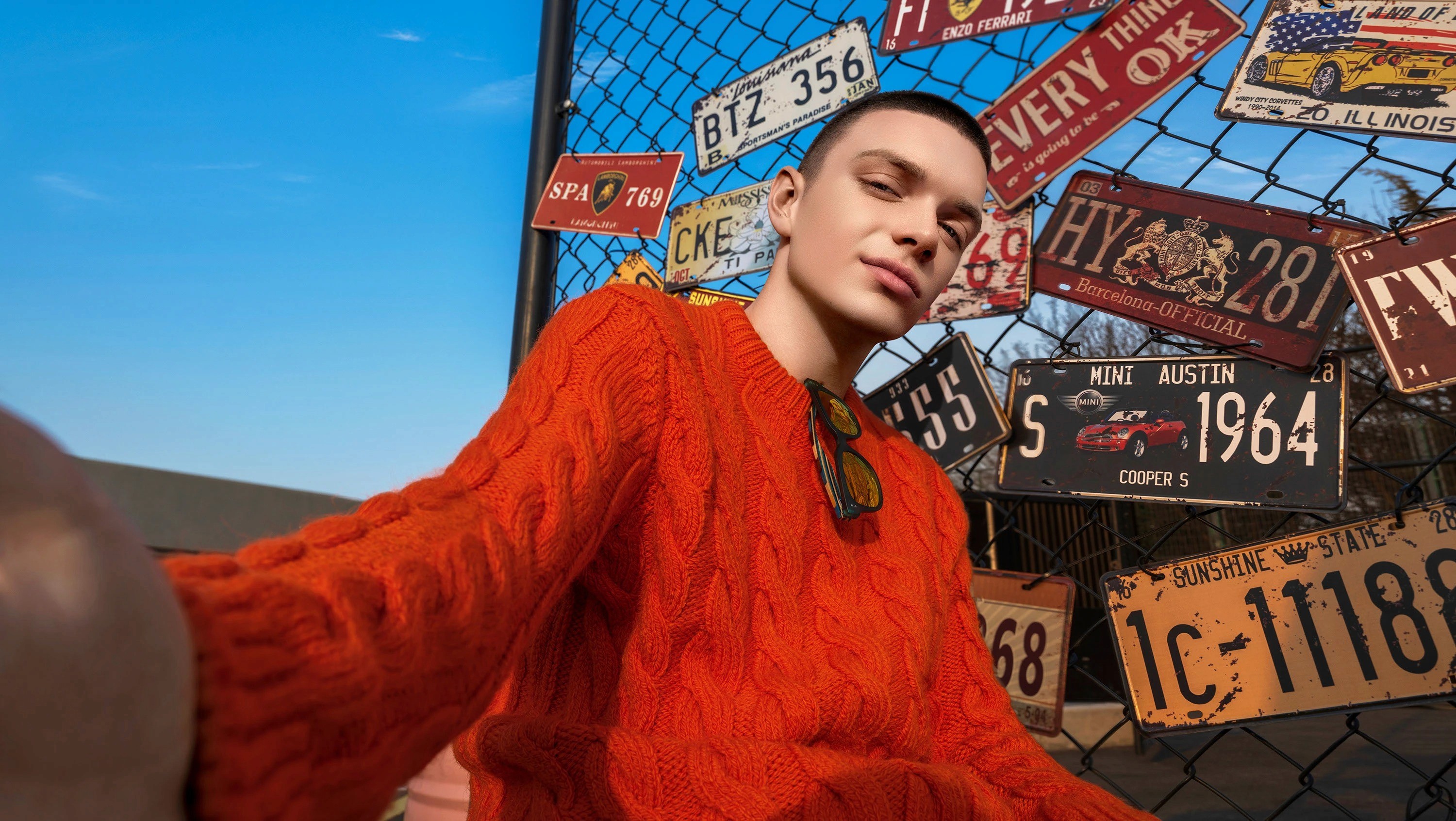 image of a man taking a selfie from a pov while wearing a red sweatshirt