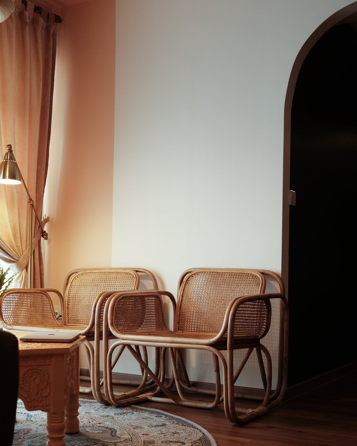 Minimalist seating corner with rattan chairs and modern accent wall, Singapore interior design