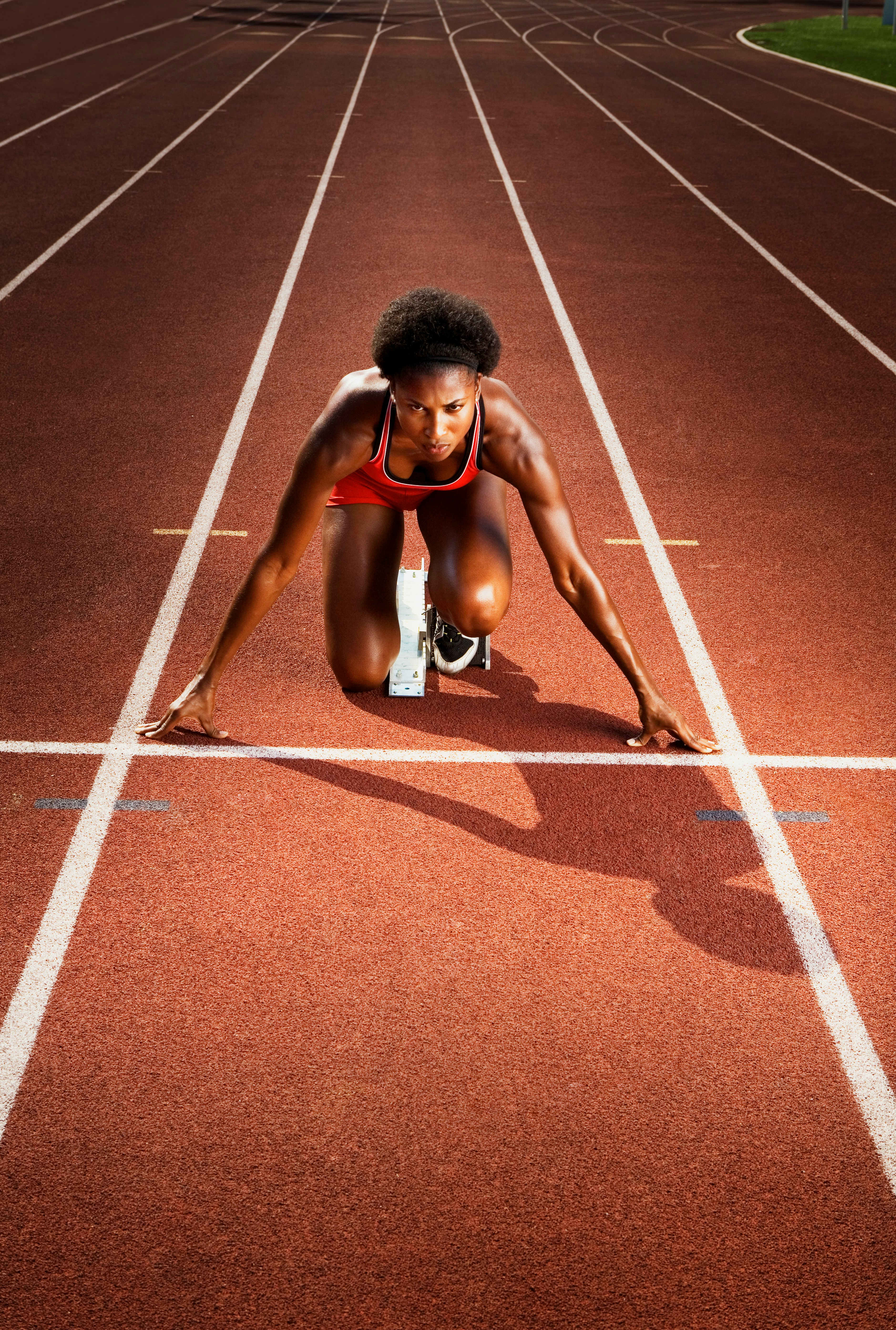 A woman running on a running track at night