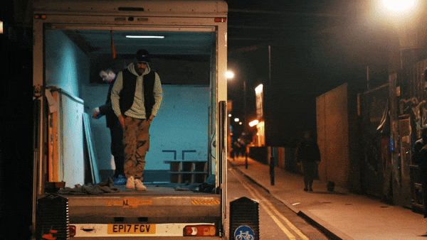 Bride in white dress walking on street, blurred motorcycle passing