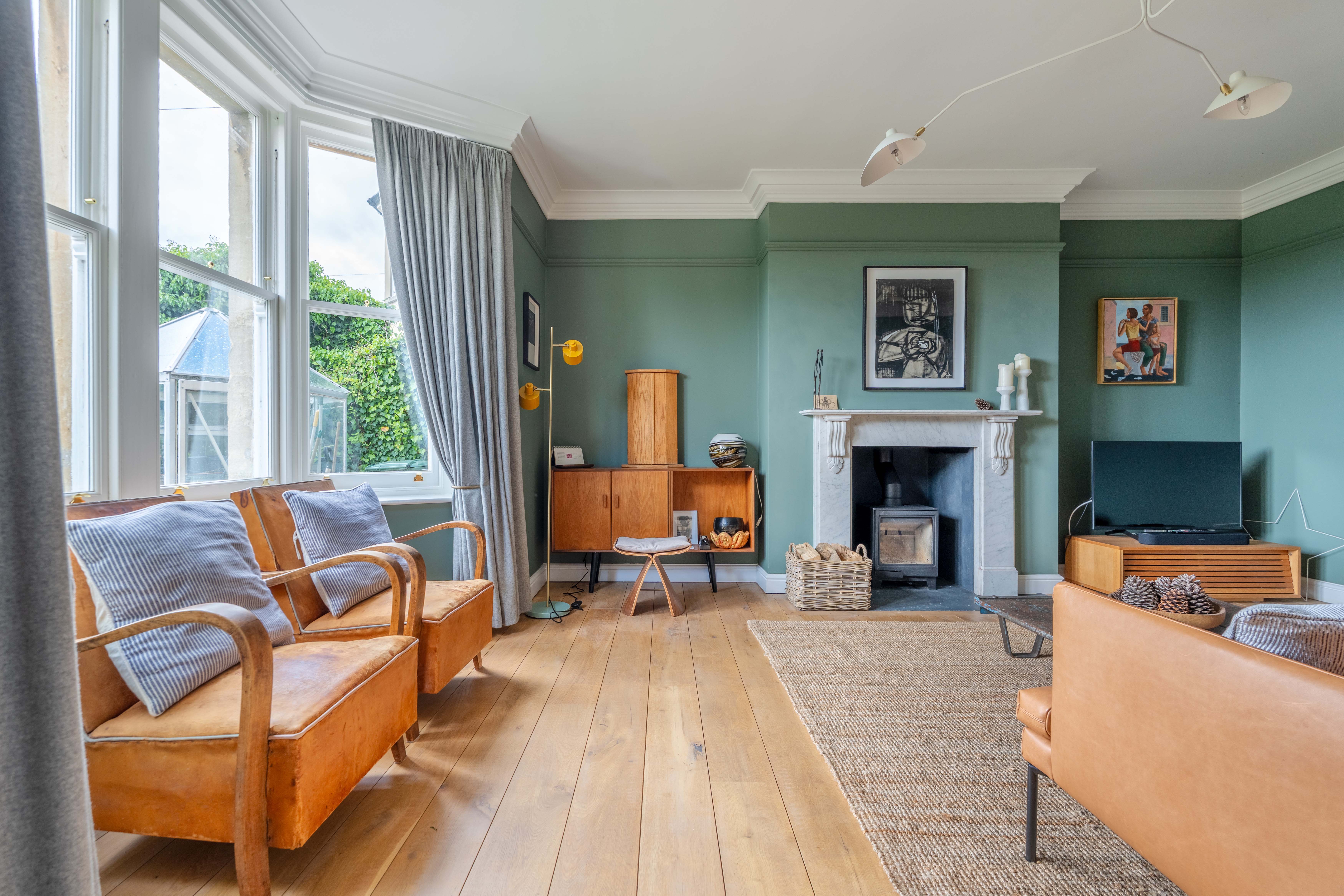Period sitting room with green walls, oak floors and original fireplace, 1 Belcombe Place Bradford-on-Avon — Captura Media