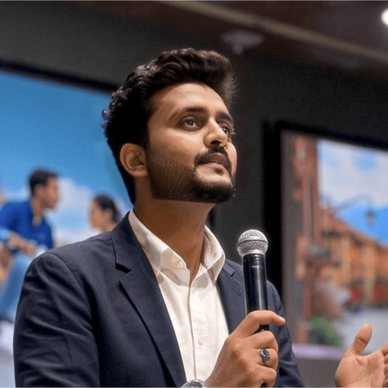Profile portrait of a man in a white shirt against a light background