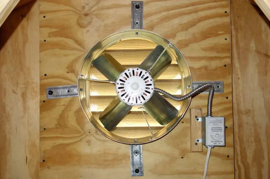 Commercial electrician in safety gear servicing large industrial circuit breaker panel