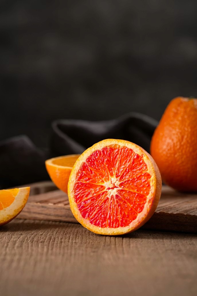 sliced orange fruit on brown wooden table
