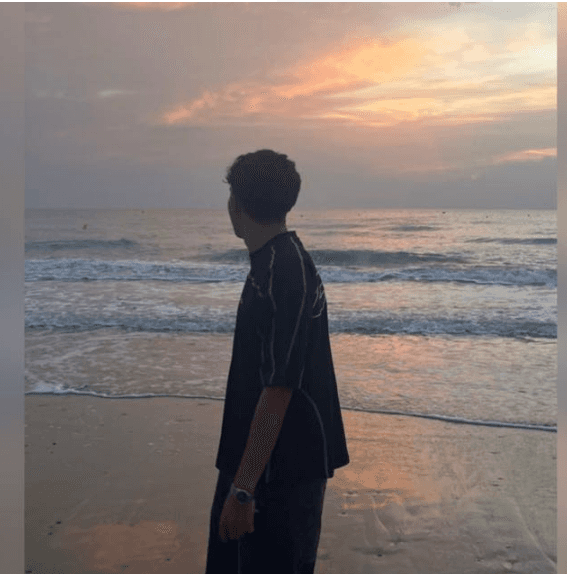 man standing near white wall