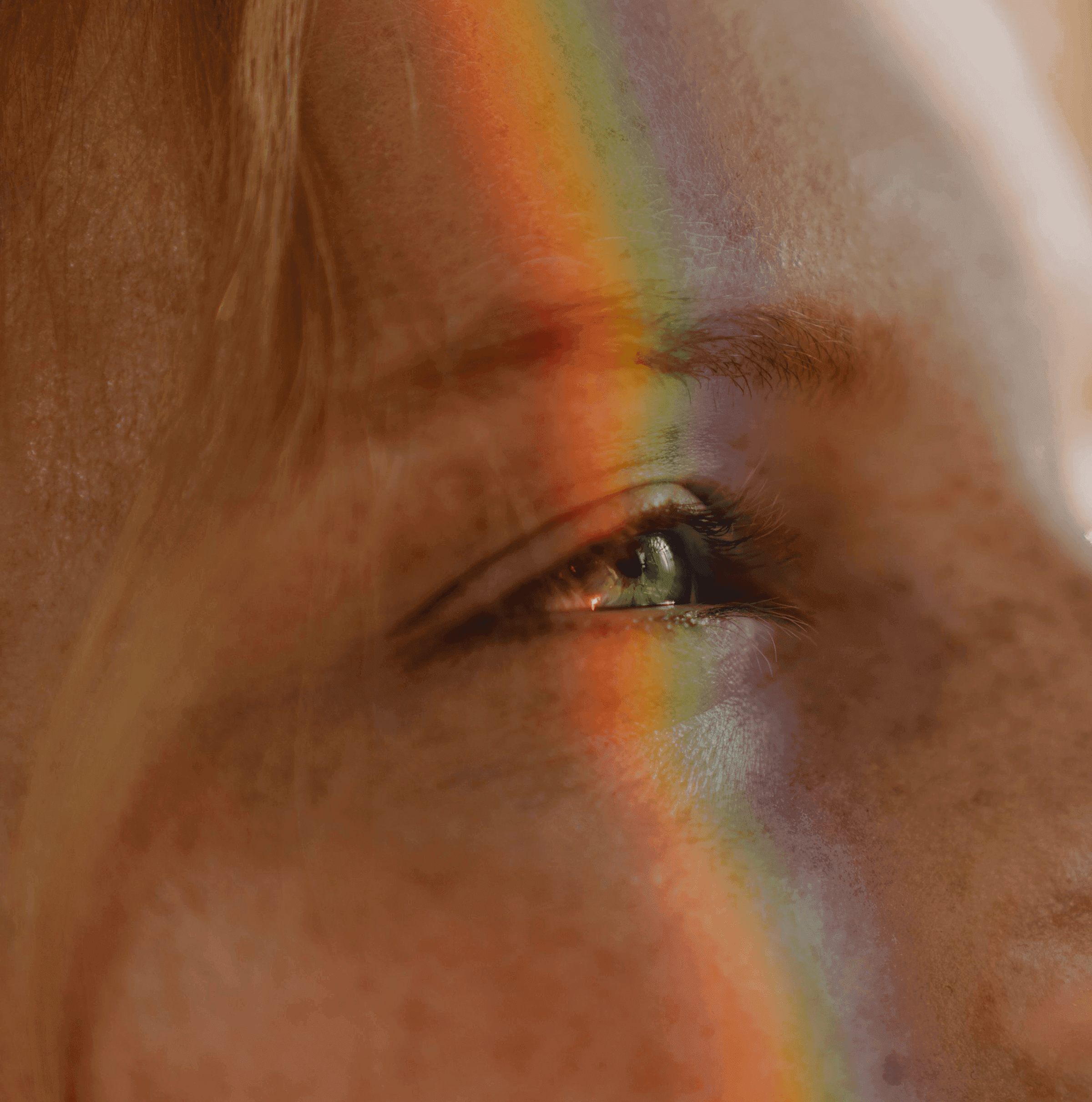 Close-up of a person with braided buns, sunglasses, and a leather jacket, set against a gradient background for a dramatic effect.