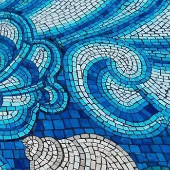 Intricate blue and white mosaic pool with swirling patterns in a luxury Arizona setting.