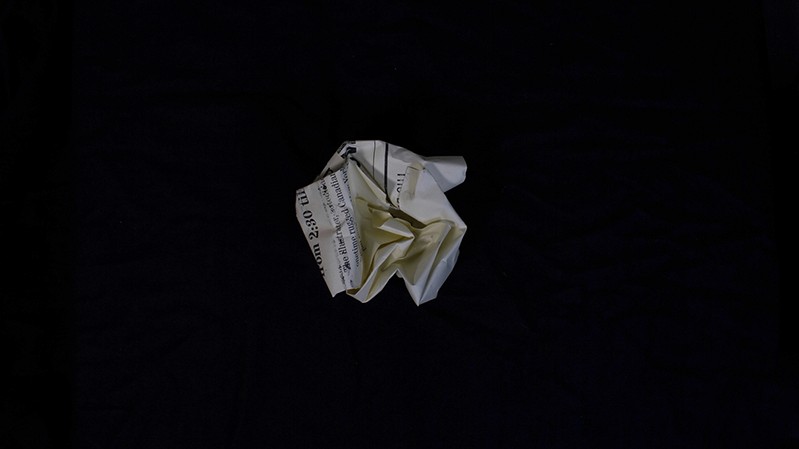 a tossed piece of paper with the Ross Macdonald event details