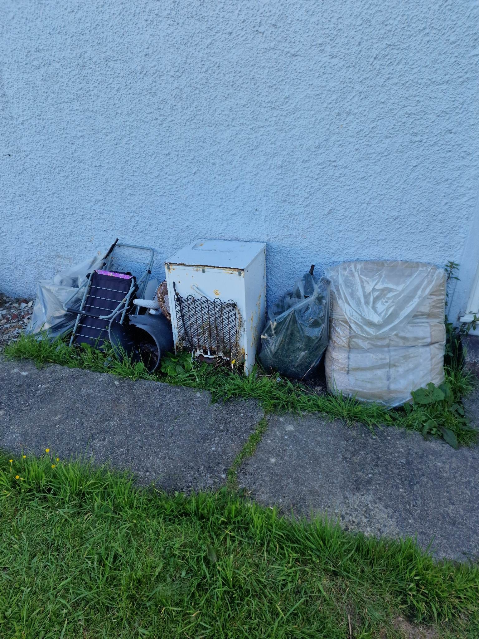 Bulky household waste and old appliances, including a fridge and garden furniture, awaiting professional collection by Moving On Removals’ licensed waste removal team in Plymouth.