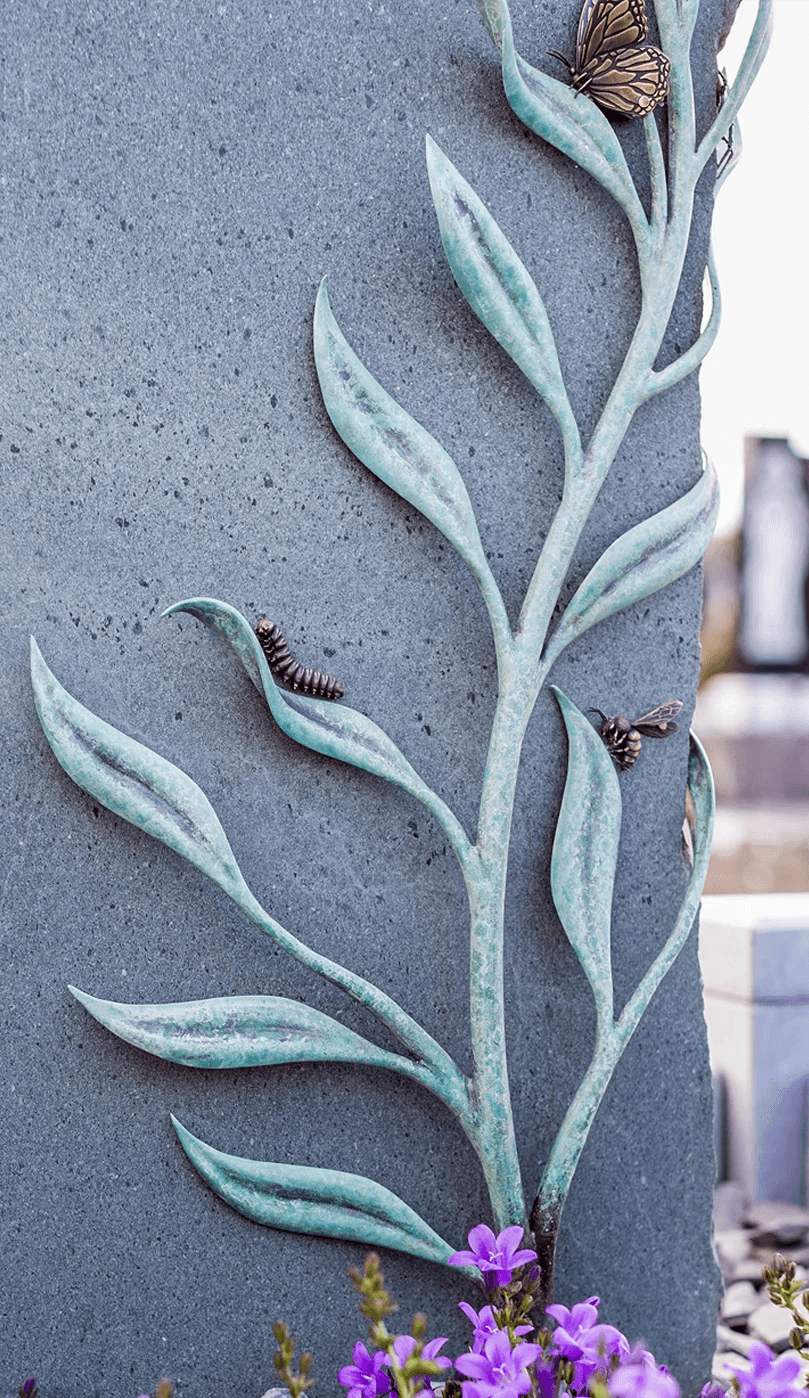 A wide shot of a detailed bronze angelfish sculpture swimming amidst vibrant green patinated metal coral reef formations, designed as an independent fine art objet d’art by Shaun Leane.