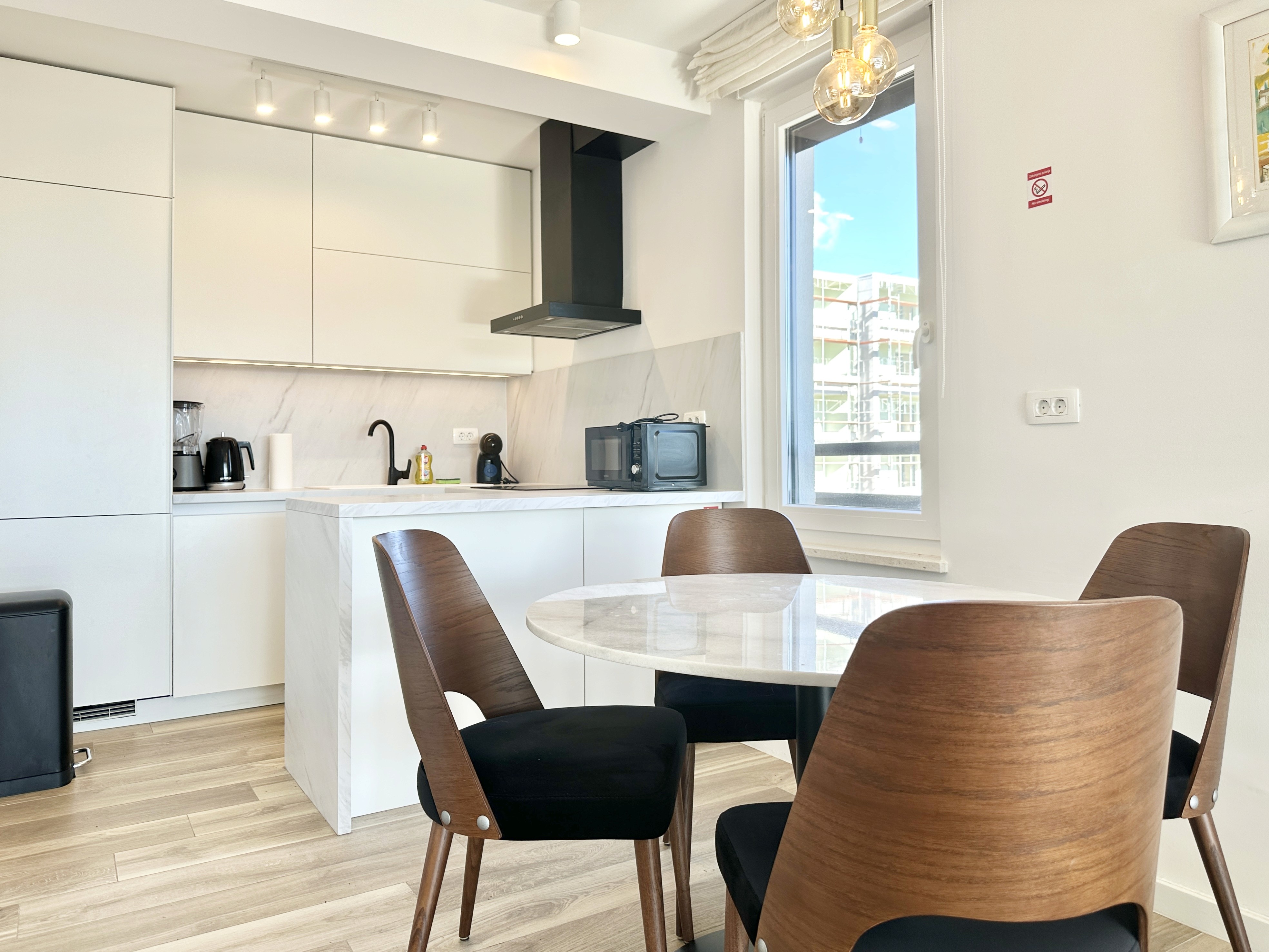 Industrial style bathroom with wooden vanity and hanging plants.