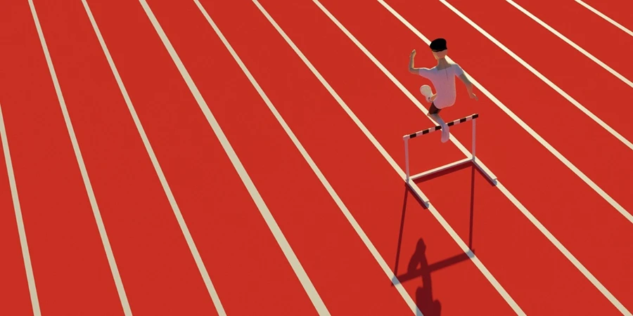 Person running on a red track jumping over a hurdle, symbolizing overcoming barriers or challenges.