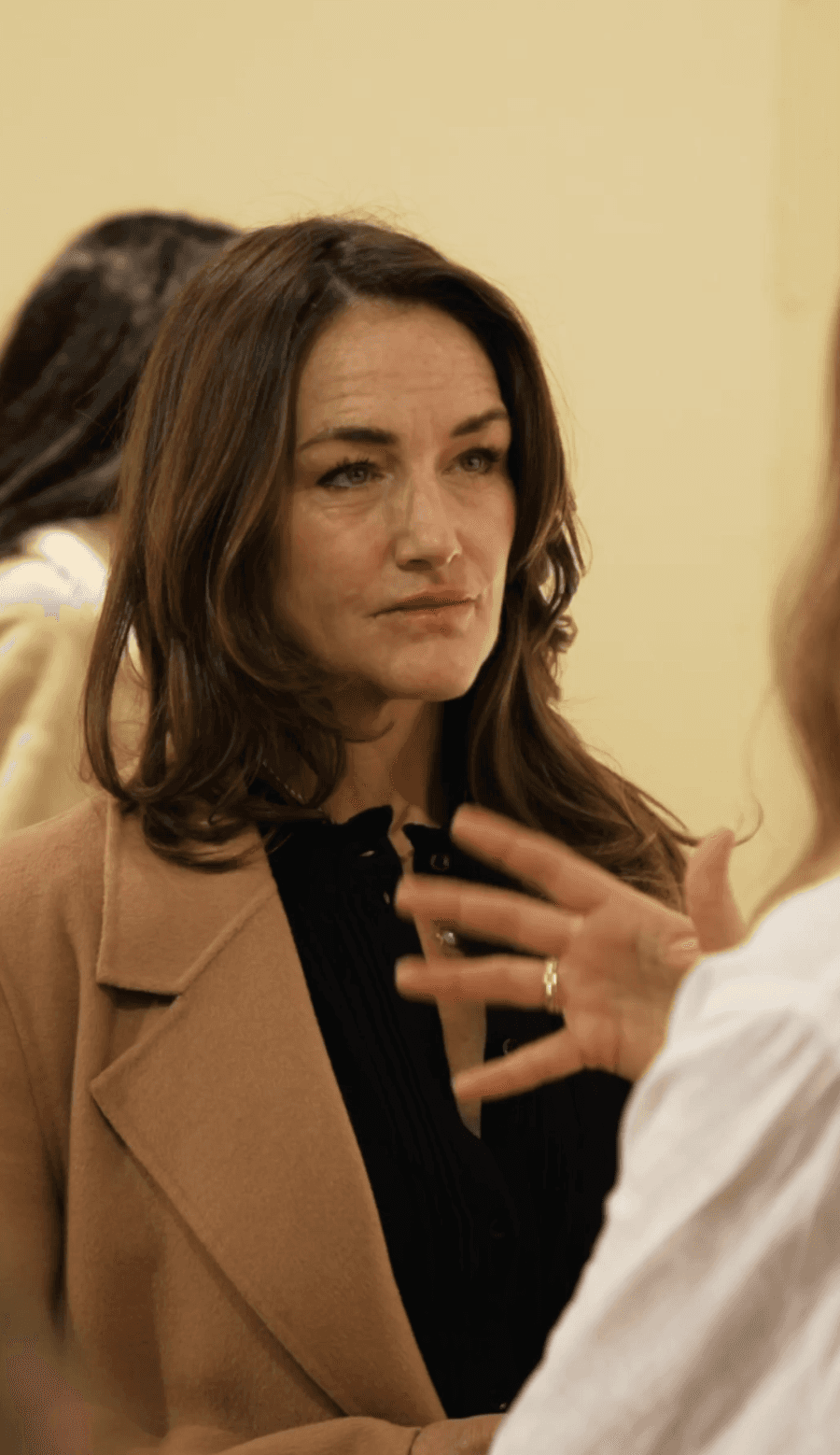 Bride and groom walking on street at night