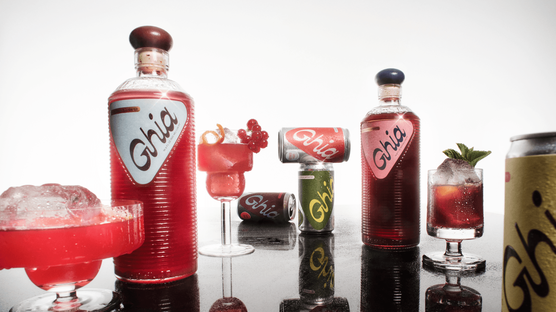 image of Ghia's aperitif drink bottles and cans, alongside fun cocktail glasses