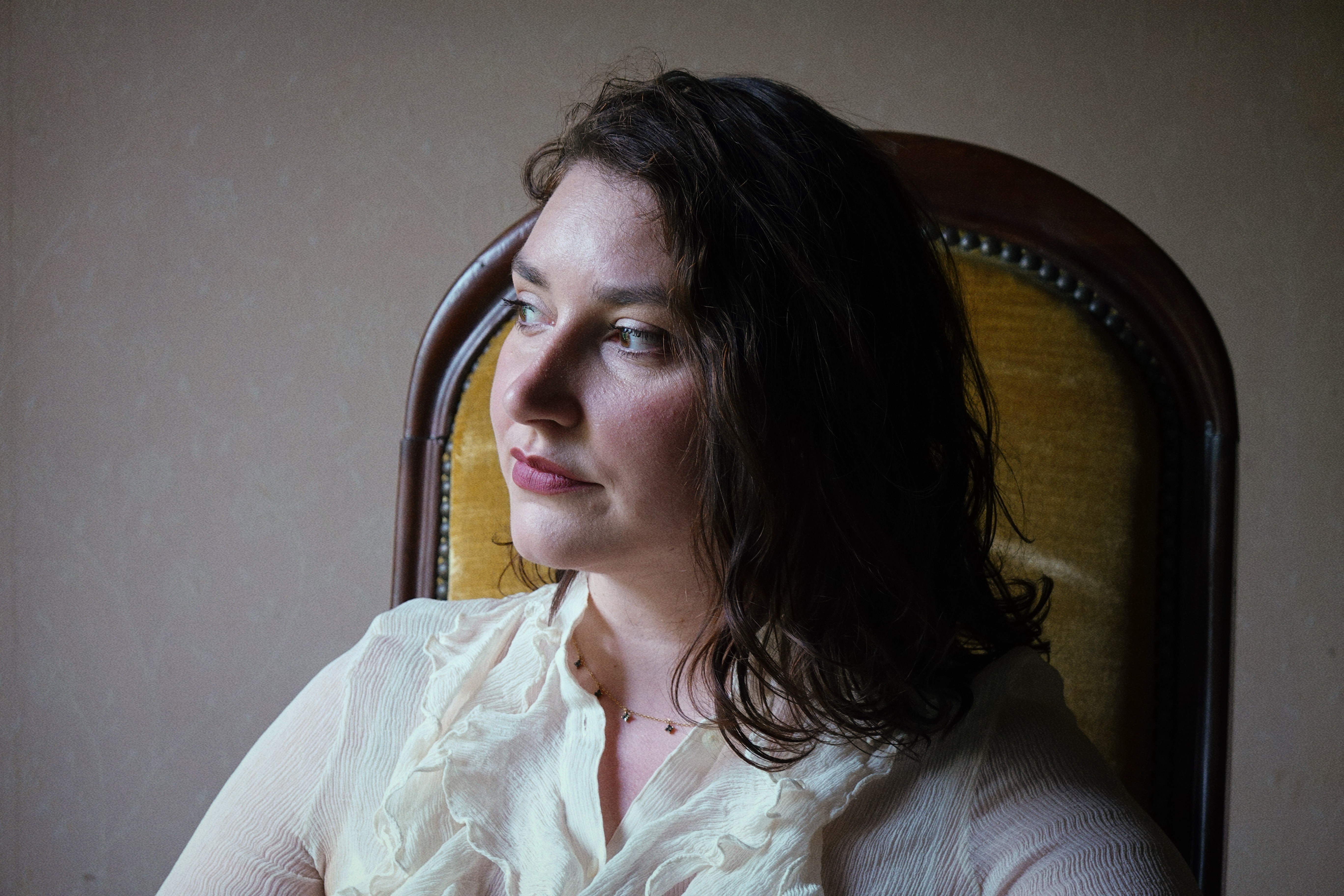 a woman wearing a black coat and a white scarf