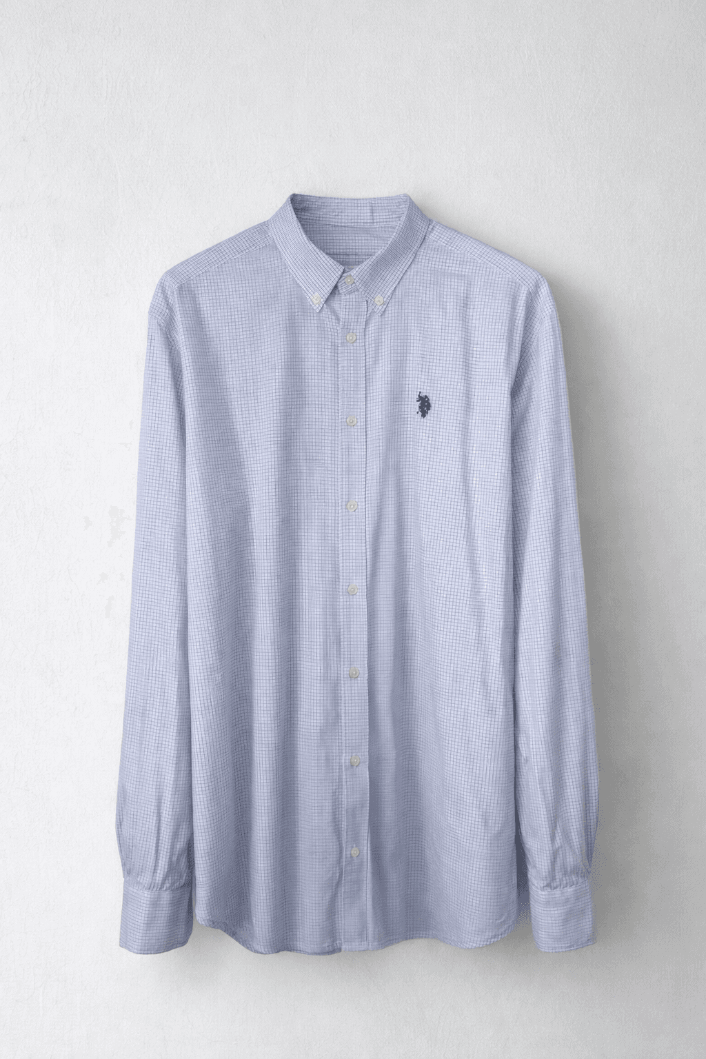 Light blue checkered button-up shirt hanging