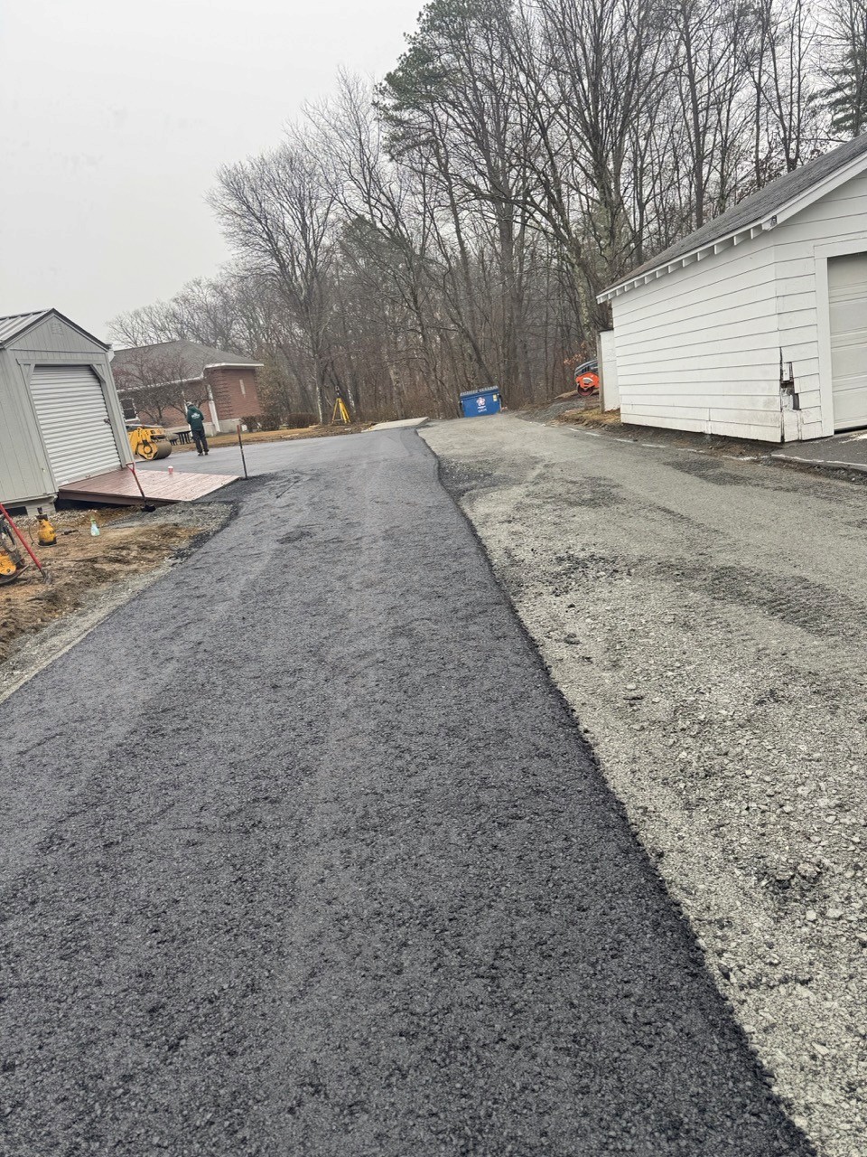 Before: Gravel-base driveway graded to a garage