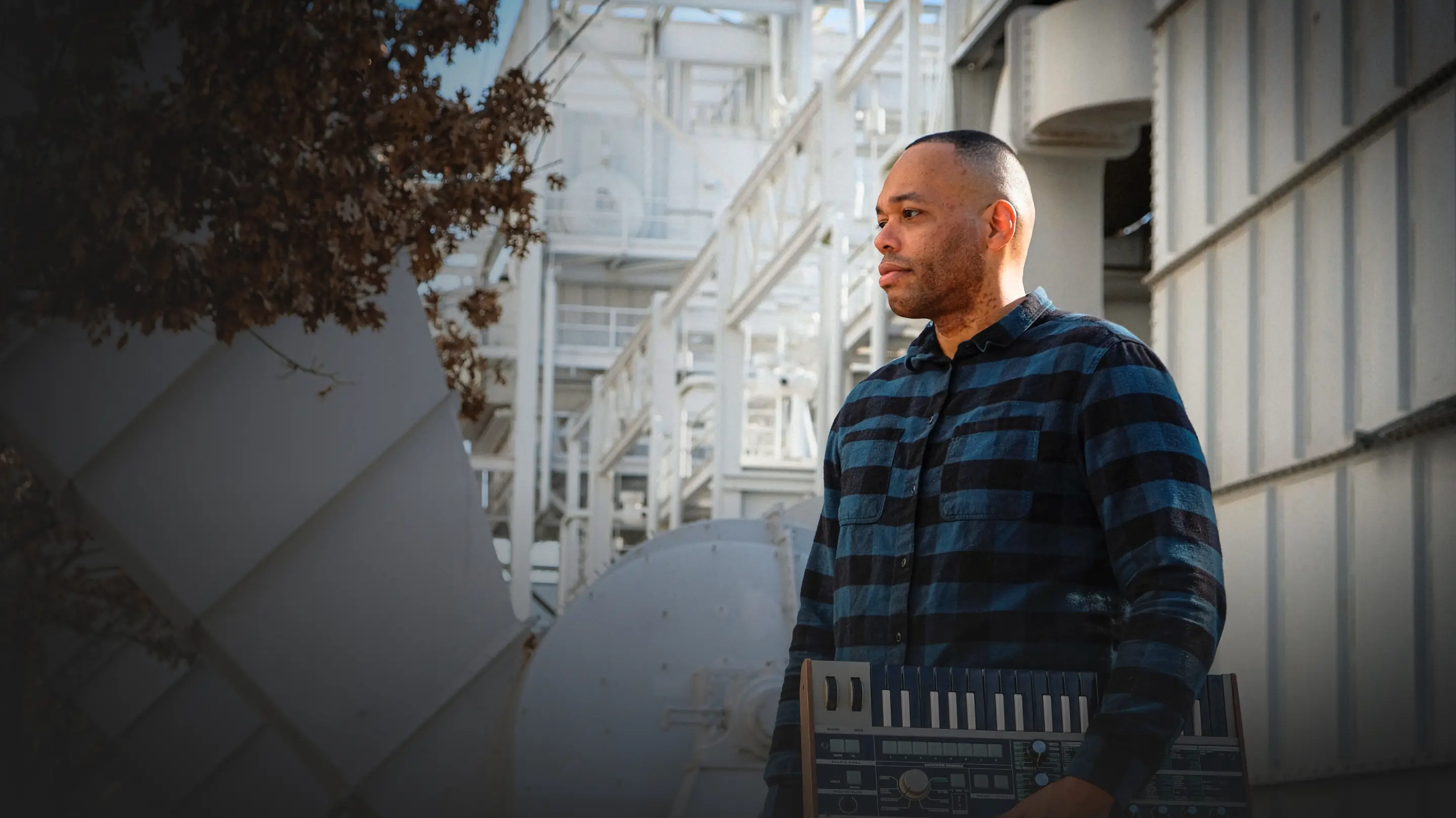 ARBZ — Hero photo of musician with synthesizer — Artist brand identity