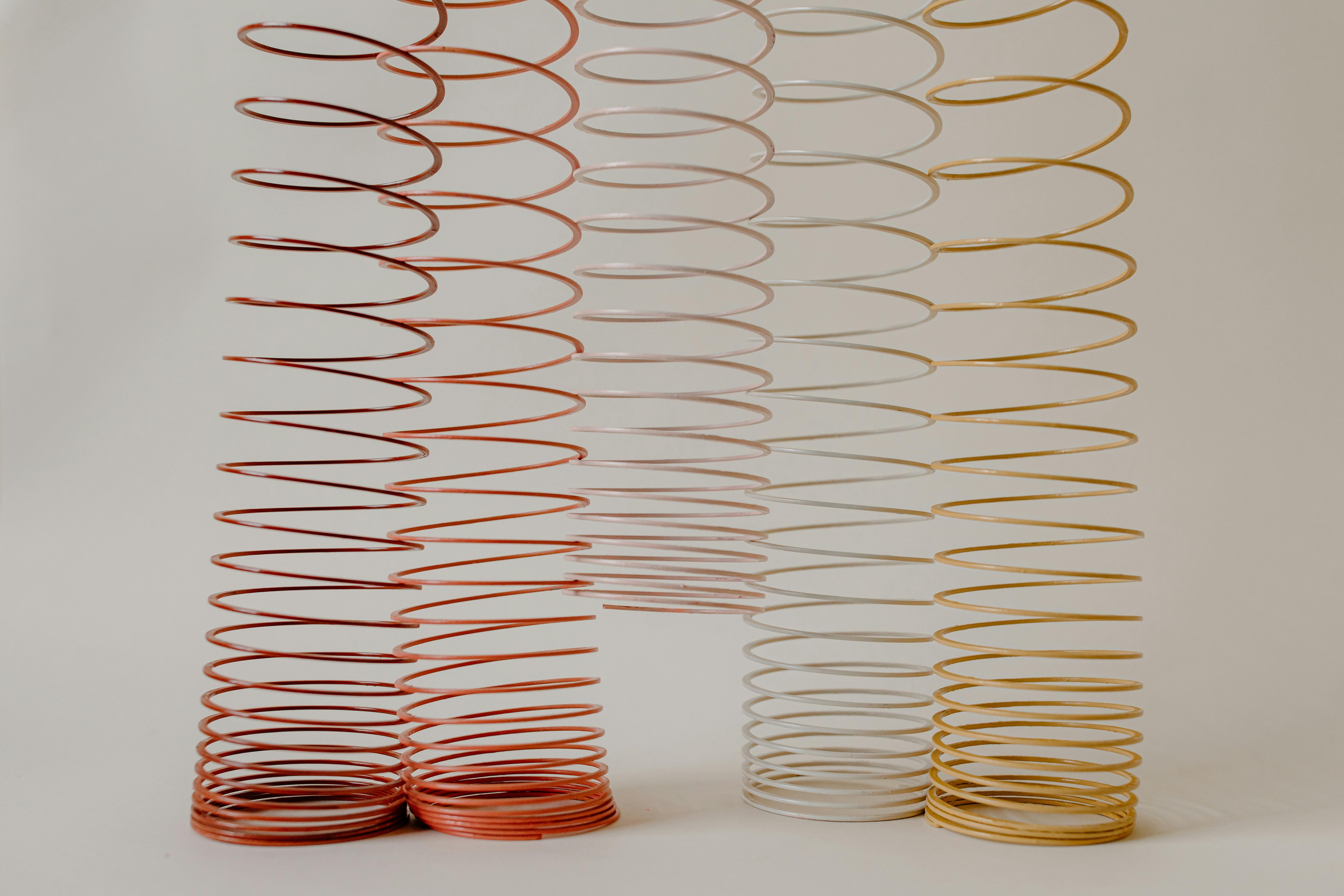 Coiled metal springs arranged in gradient colors