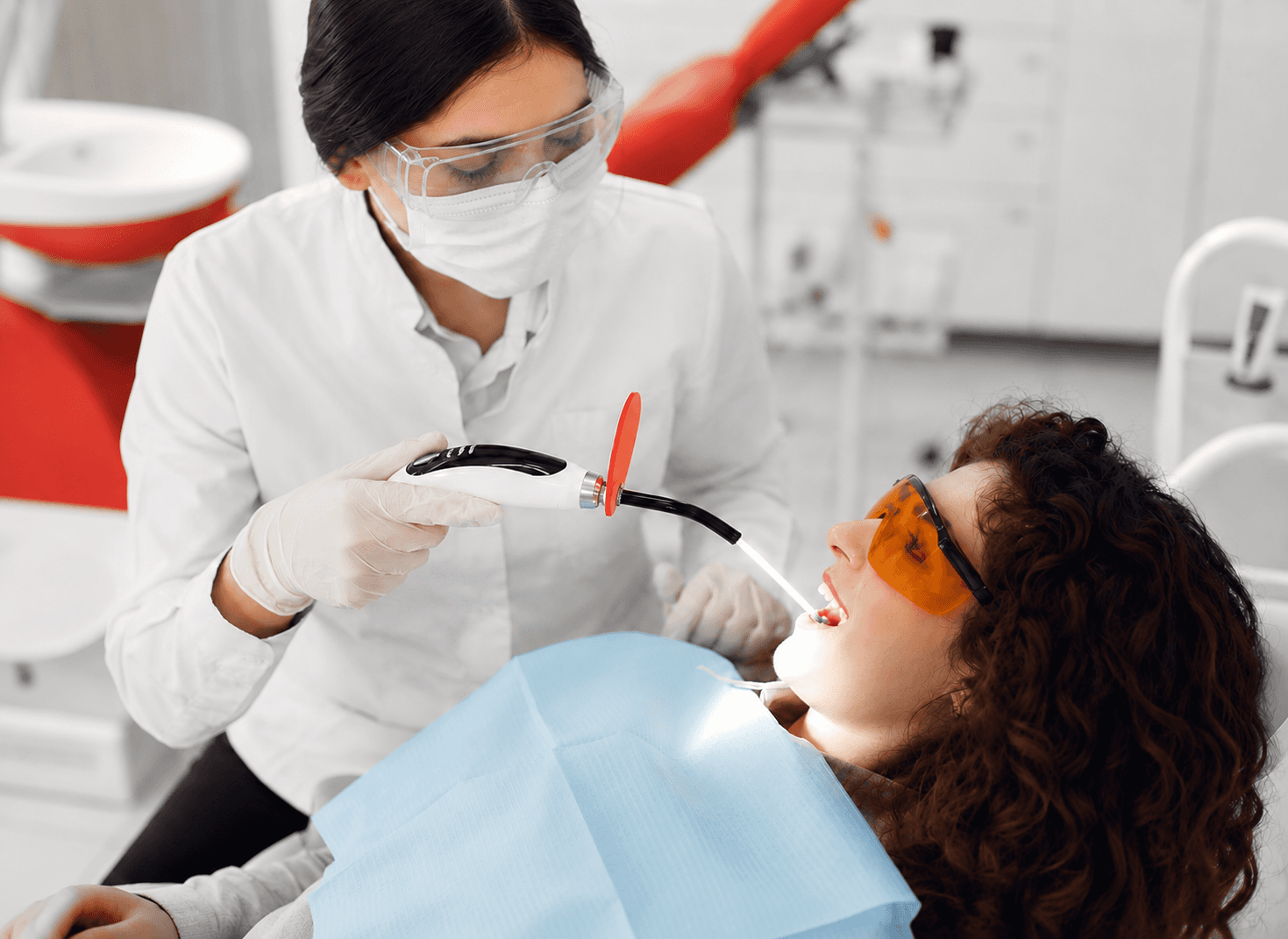 Laser dentistry procedure performed with protective eyewear in modern dental clinic. 