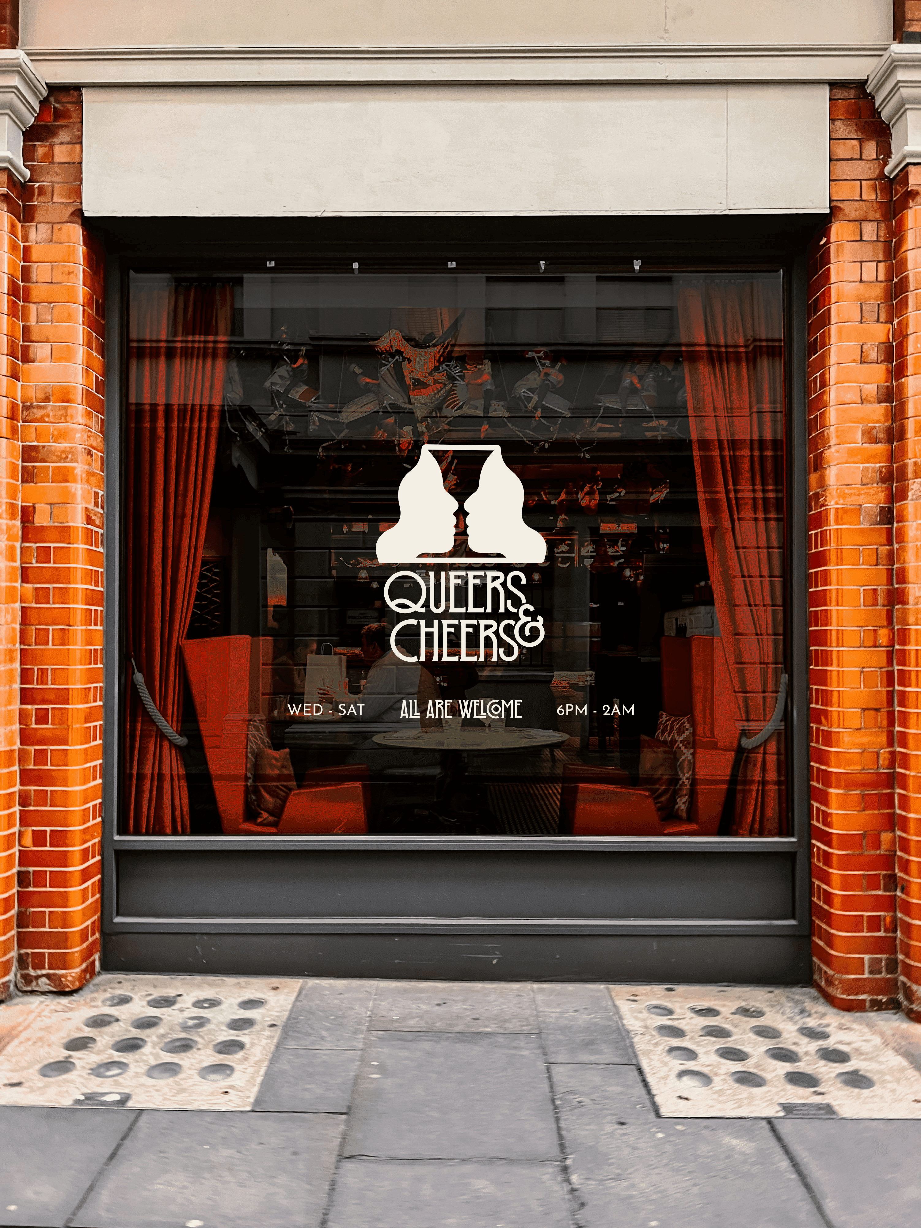 Queers & Cheers bar window, logo of two faces forming a wine glass.