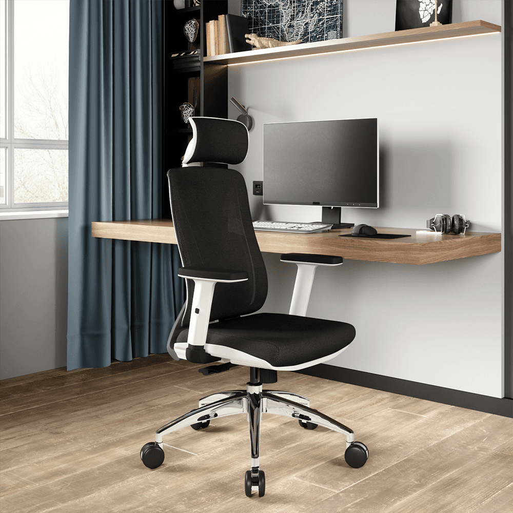 Black and white ergonomic office chair with breathable mesh back and adjustable headrest, placed at a floating wooden desk with computer monitor and keyboard in a modern home office with blue curtains and wall shelving.