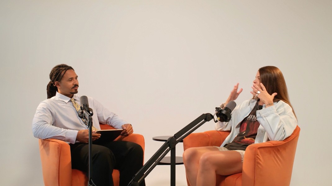 Production team working around a filmed podcast conversation
