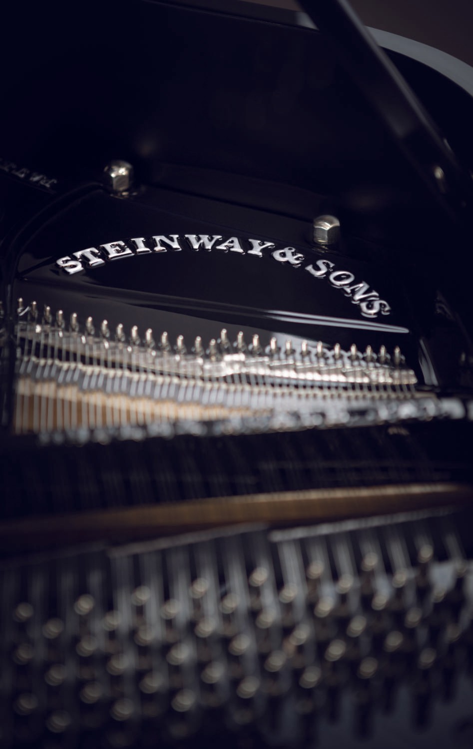A restored Steinway & Sons grand piano with a black polyester finish, black iron frame, and custom mates altar bass strings.