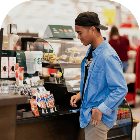 A man paying at a supermarket checkout and getting cashback