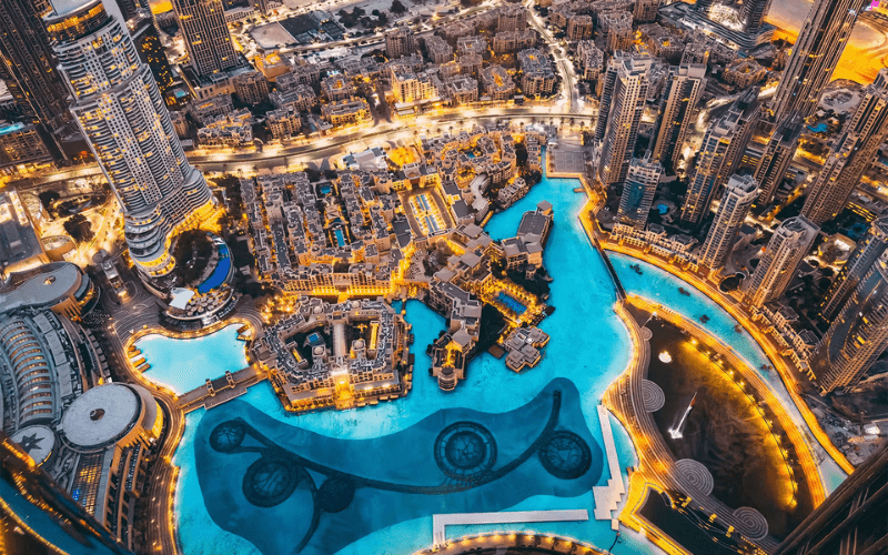 View of Dubai at night, from the Burj Khalifa. The lagoon lit, and the lights of the city shining