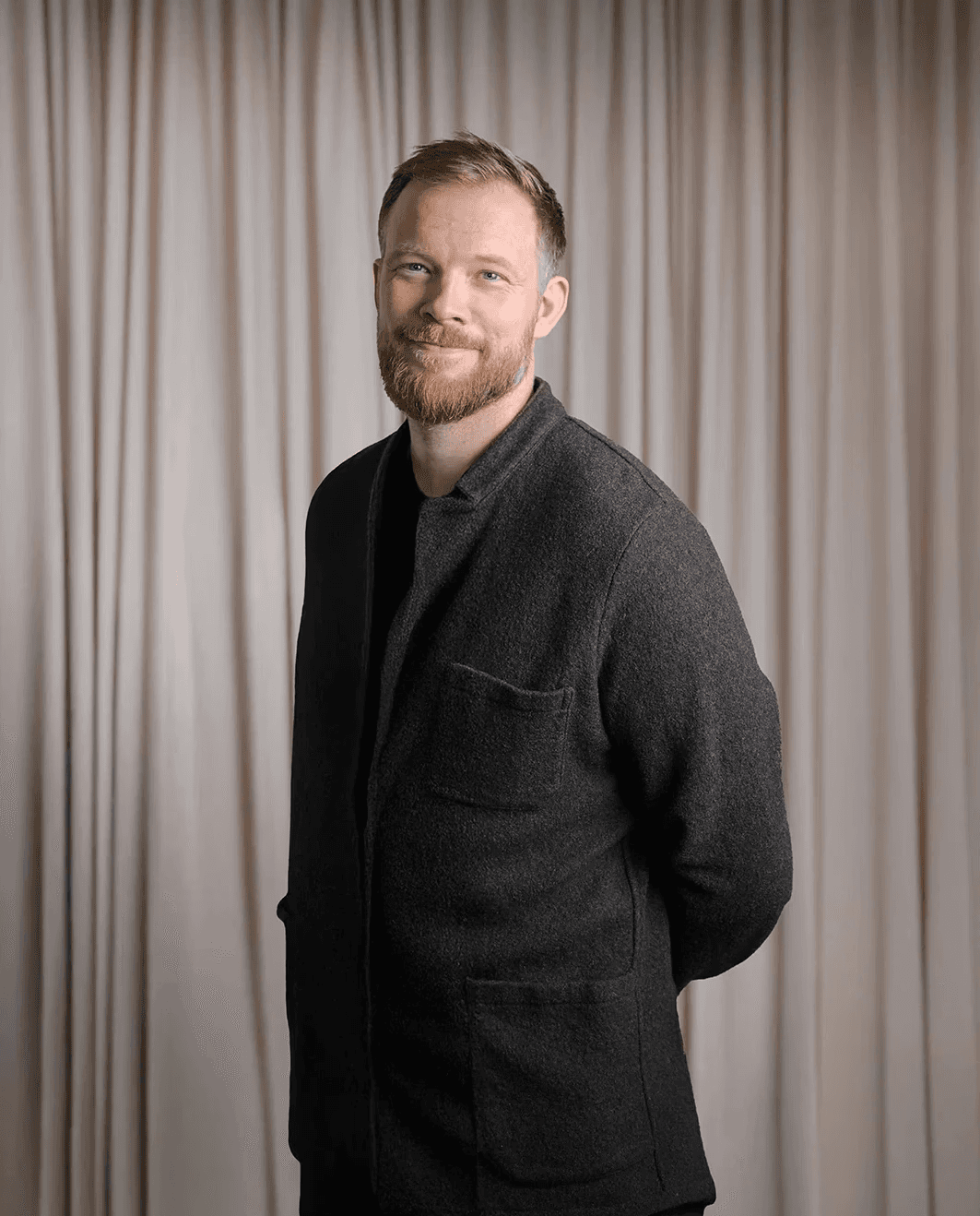Man tending plants inside a greenhouse