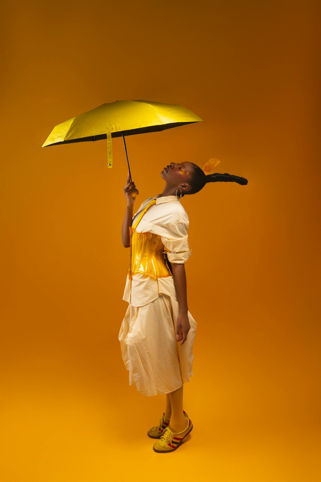 Artistic portrait of woman with a yellow umbrella