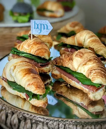 Mini croissants de jamón serrano y rúcula para catering de cóctel y eventos en Santiago.