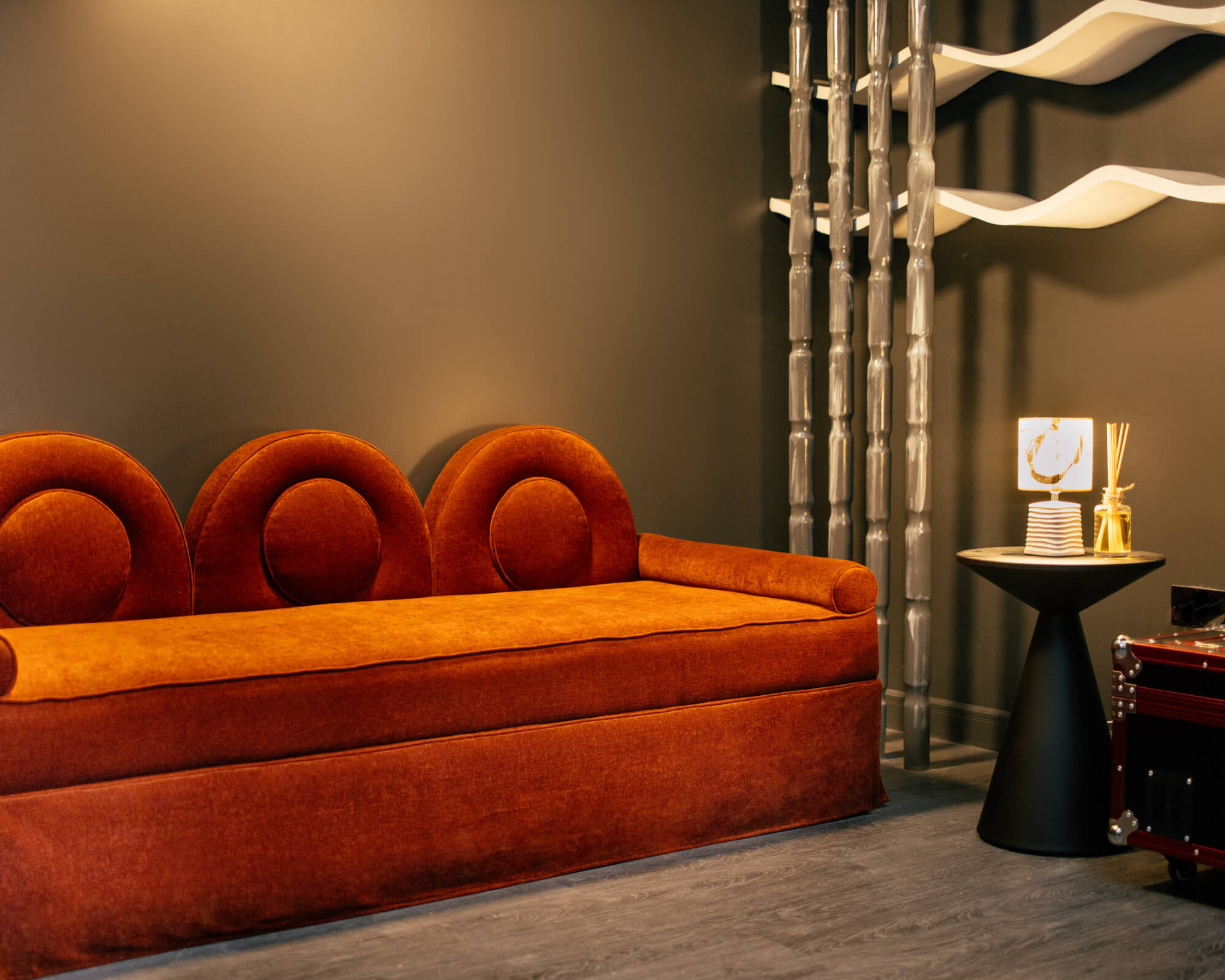 An orange cube-shaped side table is shown.