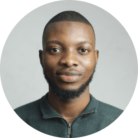 A headshot of Dipo smiling slightly.