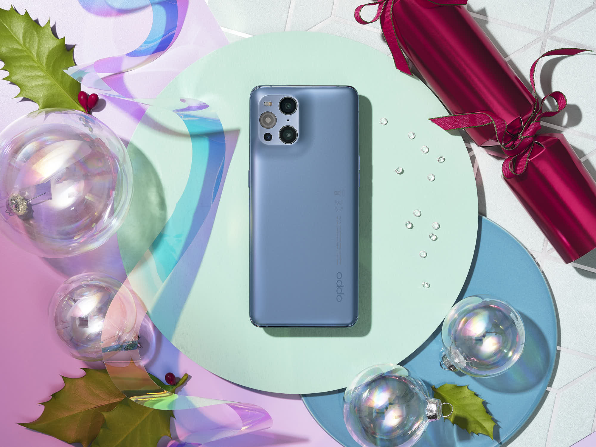 Elegant smartphone on festive background with colorful decor and holiday ornaments.