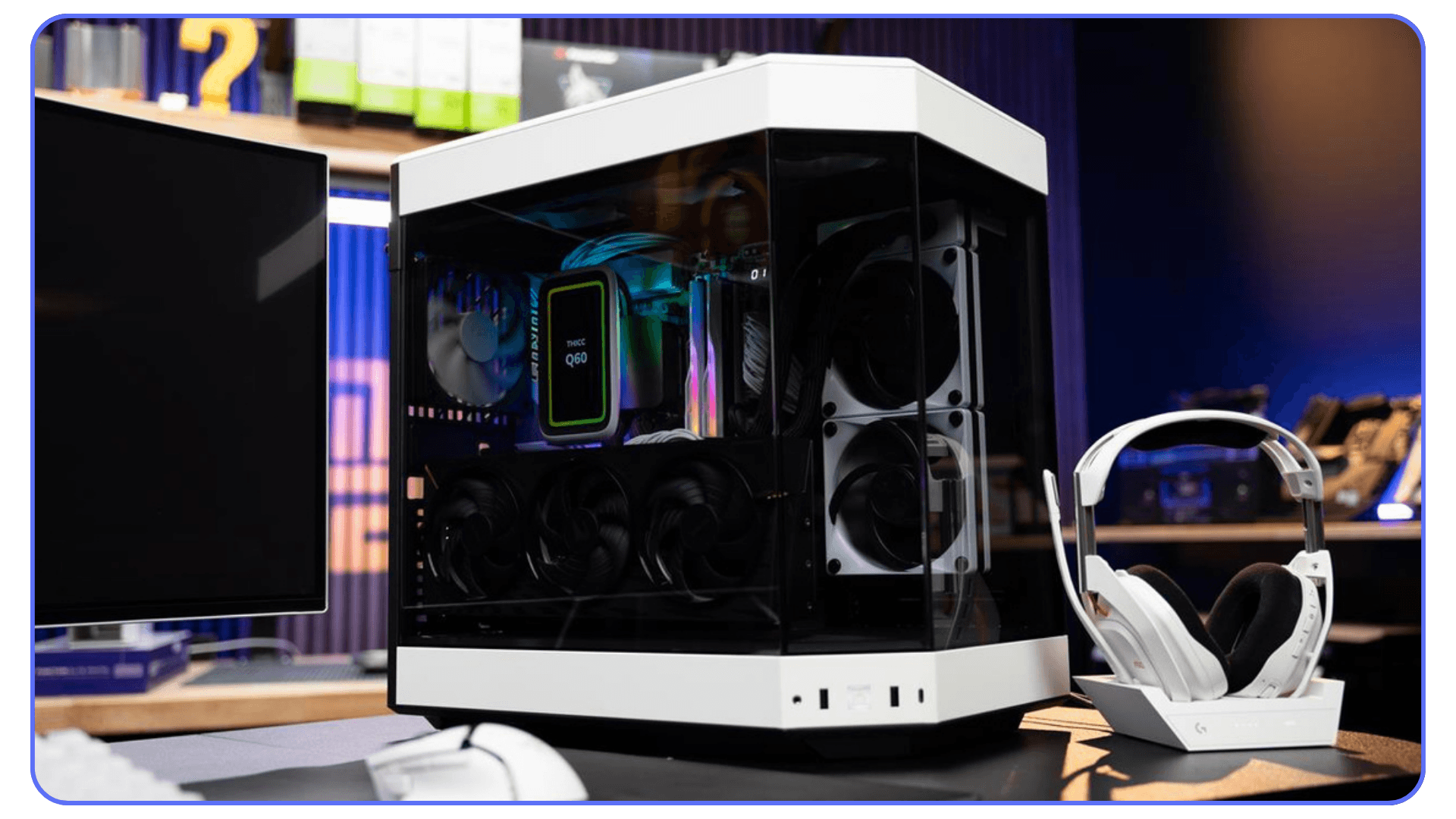 A custom white PC case with multiple cooling fans visible through the glass side panel, accompanied by a white gaming headset on a stand.