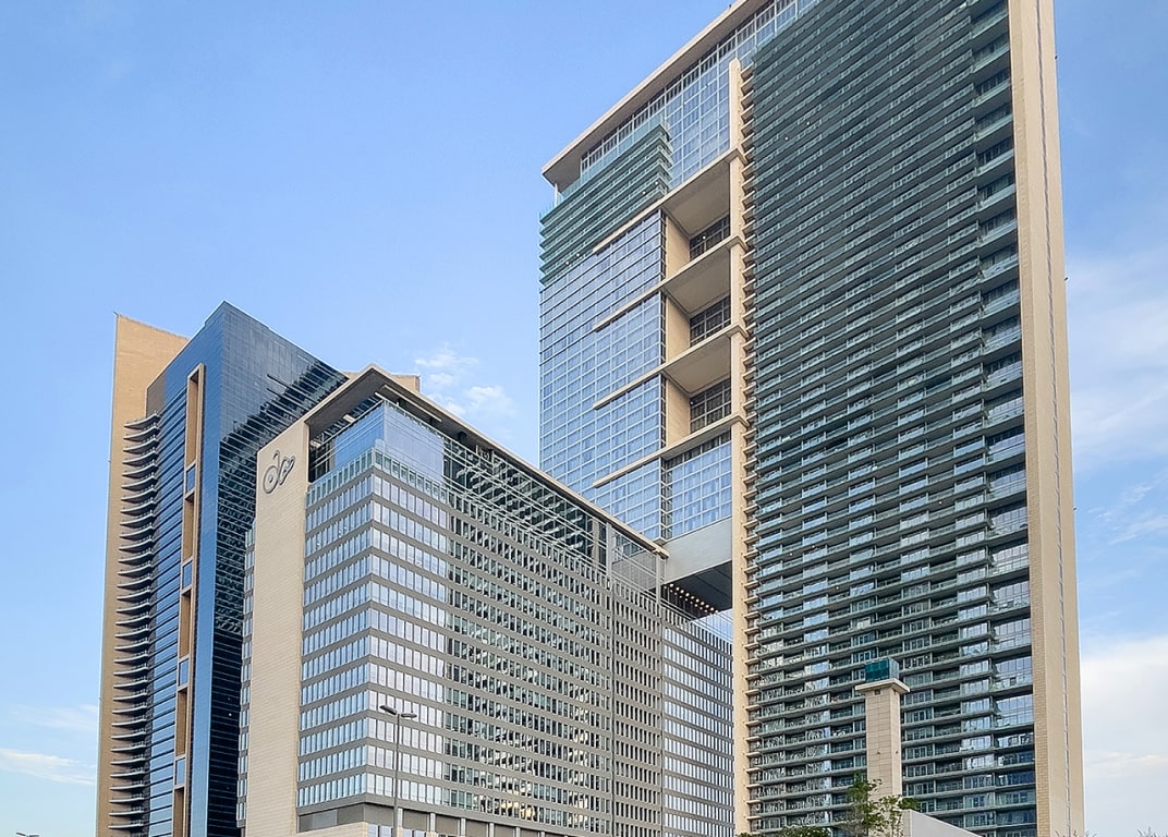 Wide architectural shot of Burj Daman towers showcasing high-end residential and commercial units.