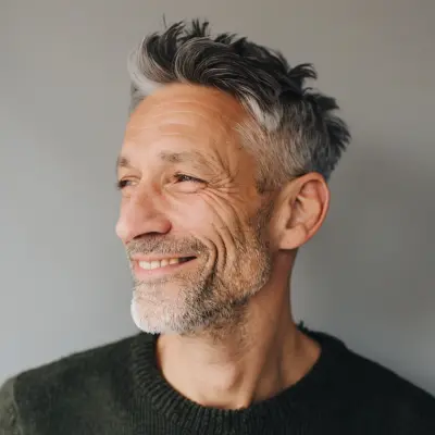 Mature man with gray hair smiling, natural light, landscaping client testimonial portrait