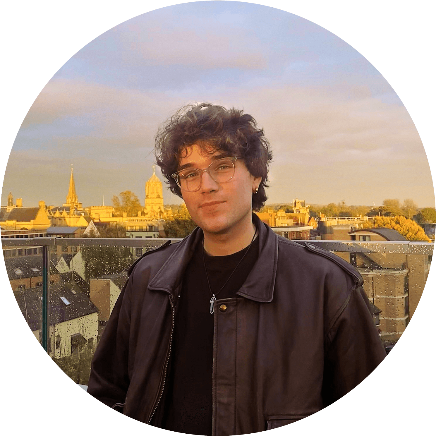 Person wearing a blue puffer jacket and red backpack standing in front of a light blue building on a city street.
