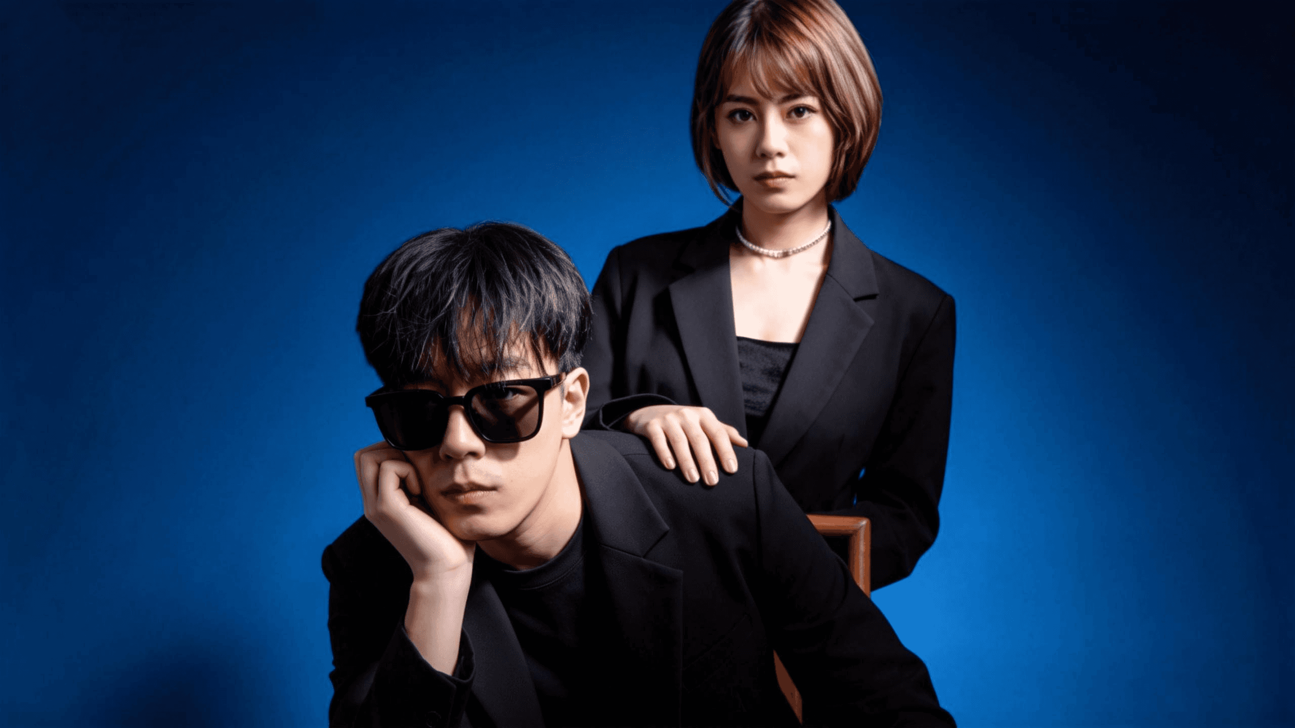 A group of four people engaged in a discussion while seated in a cozy, plant-filled setting.