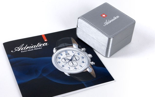 Adriatica product catalogue and branded watch box – coordinated silver and red identity across print and packaging.