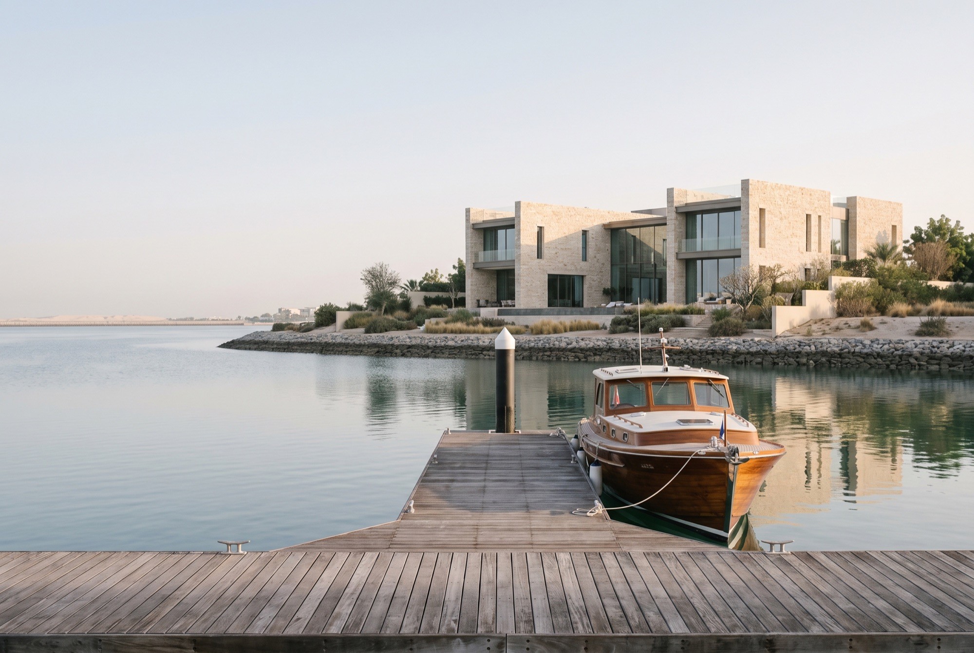 A wooden motor yacht moored at a private dock on Jumeirah Bay