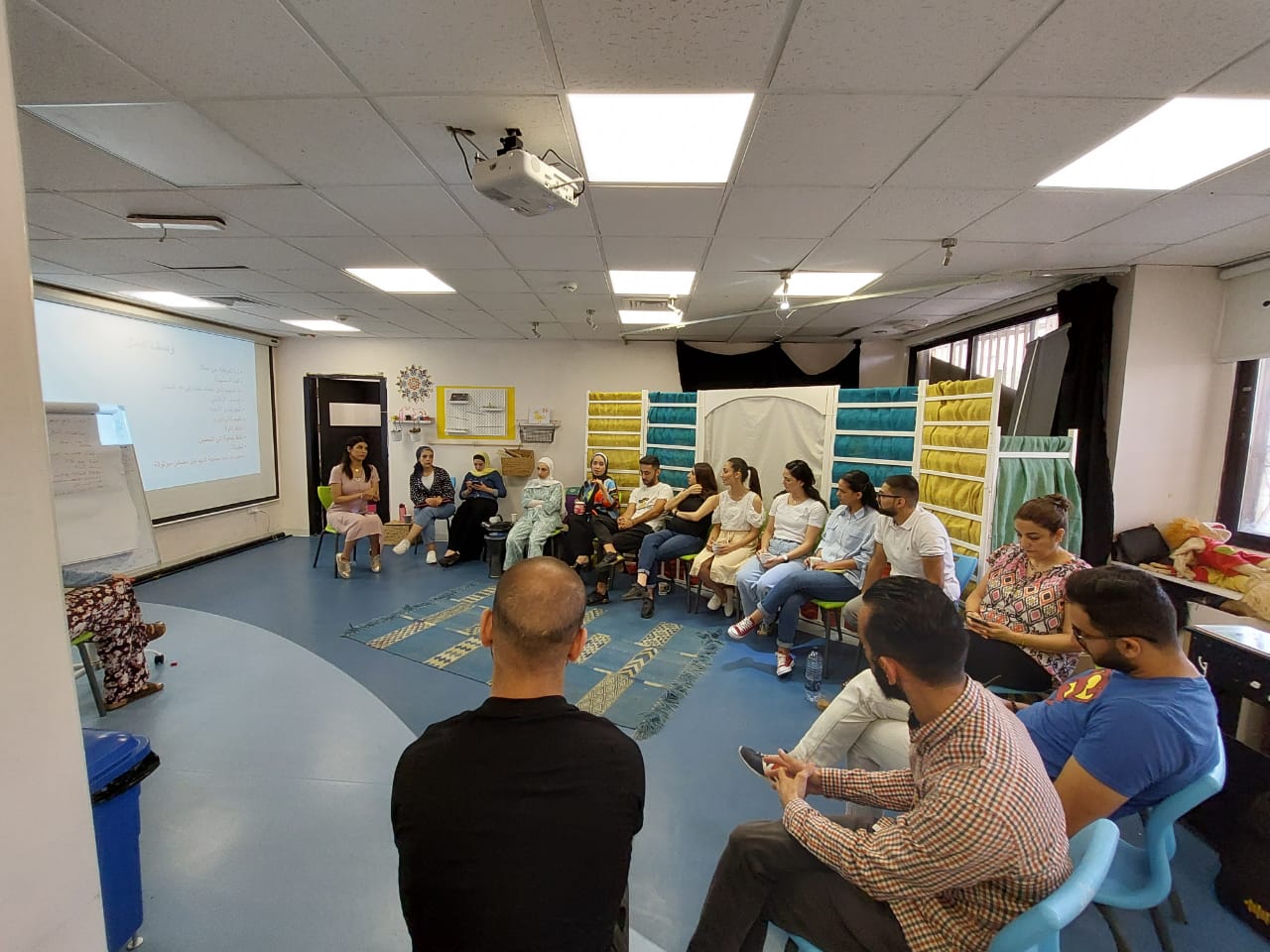 man in black crew neck t-shirt and blue shorts holding woman in white and red