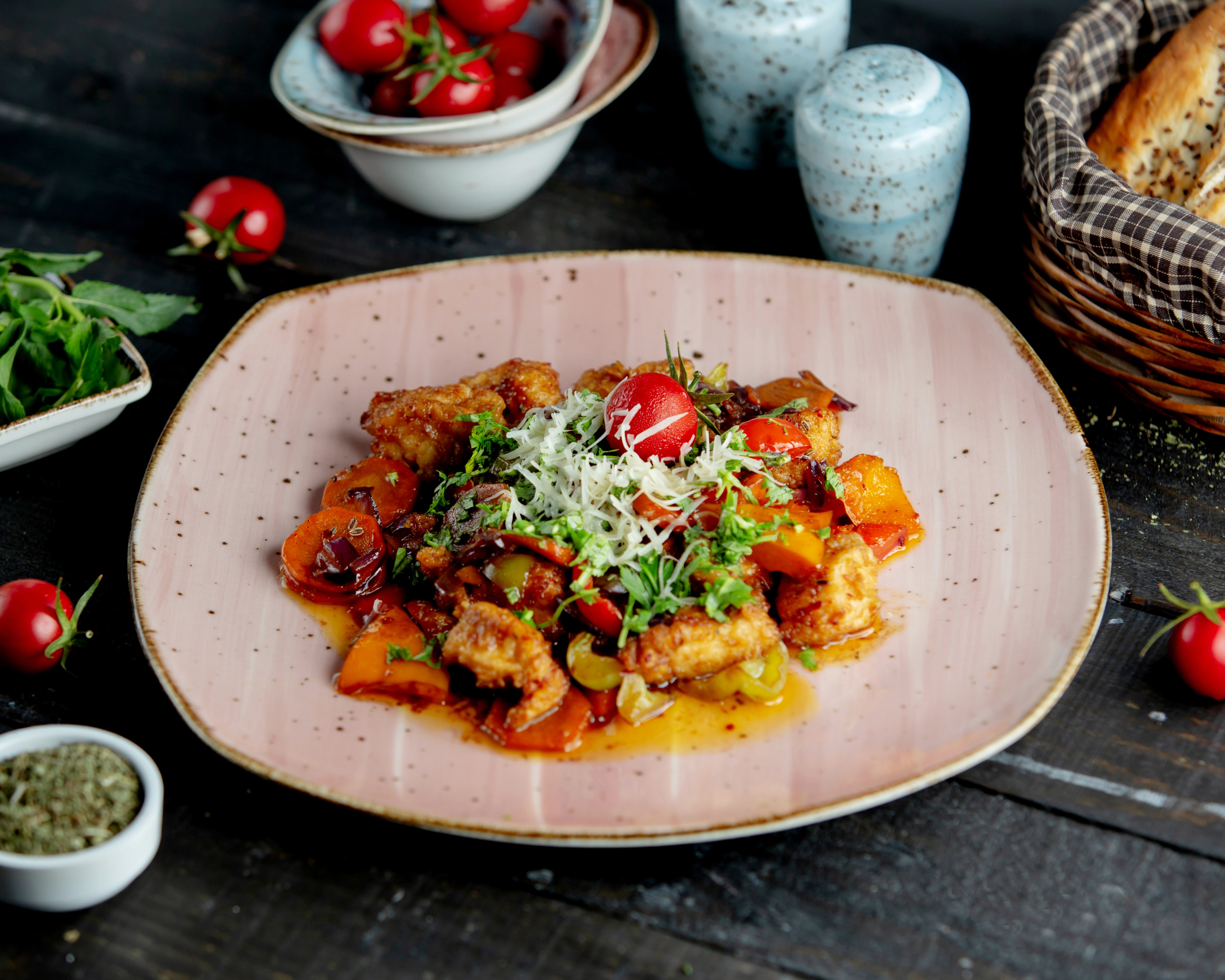Chicken stew with vegetables garnished with herbs parmesan and tomato