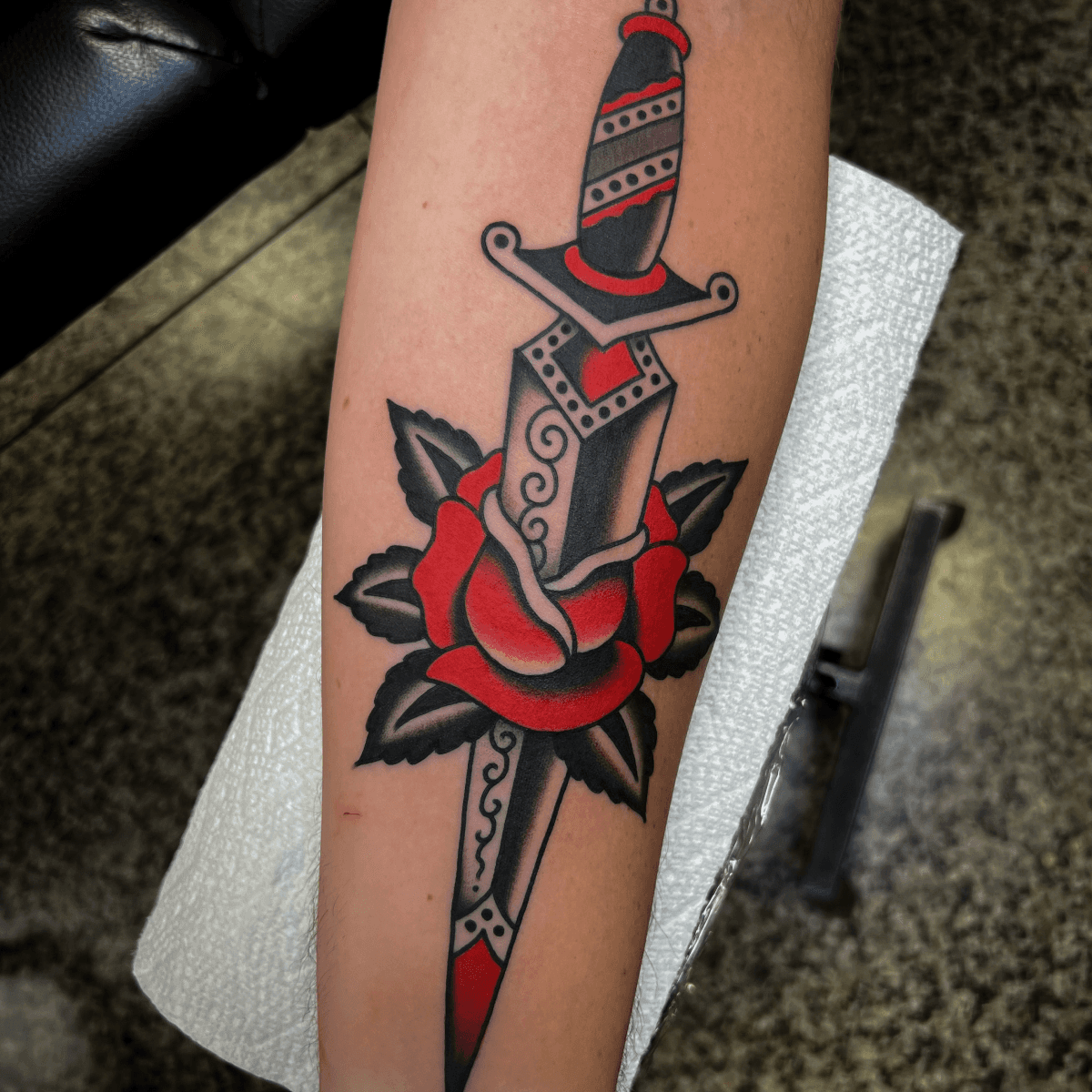 color tattoo of a rose and dagger