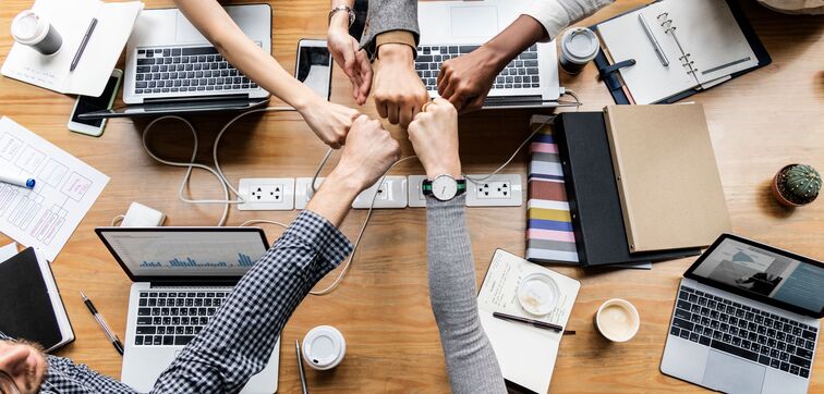 Employees giving fist bumps