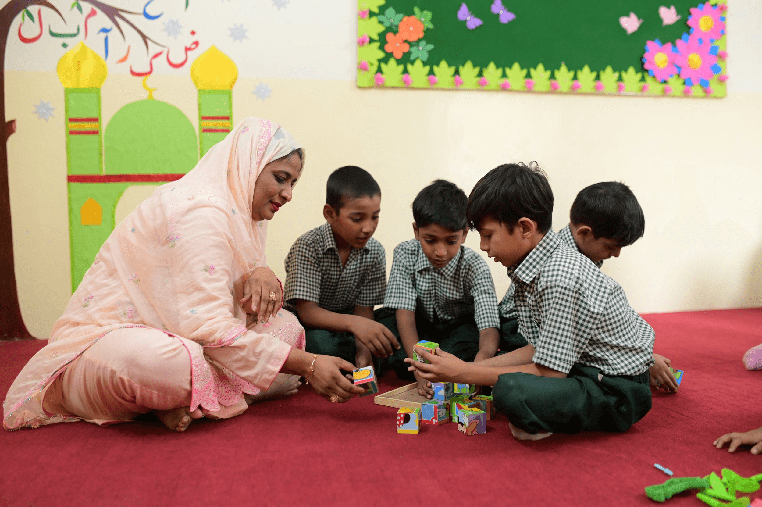 A teacher is showing a microscope to a group of students
