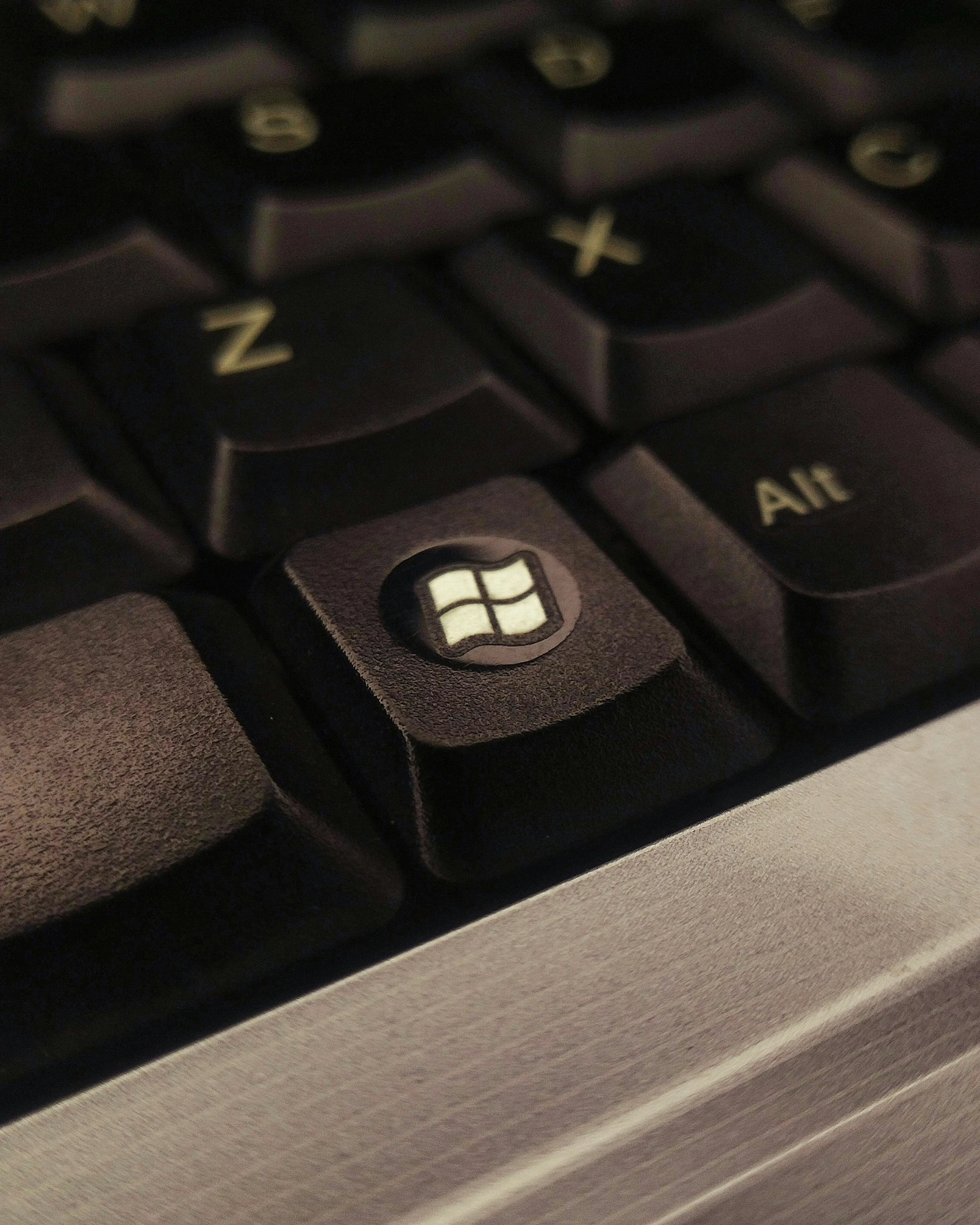 Close up shot of black keyboard focusing on the windows button