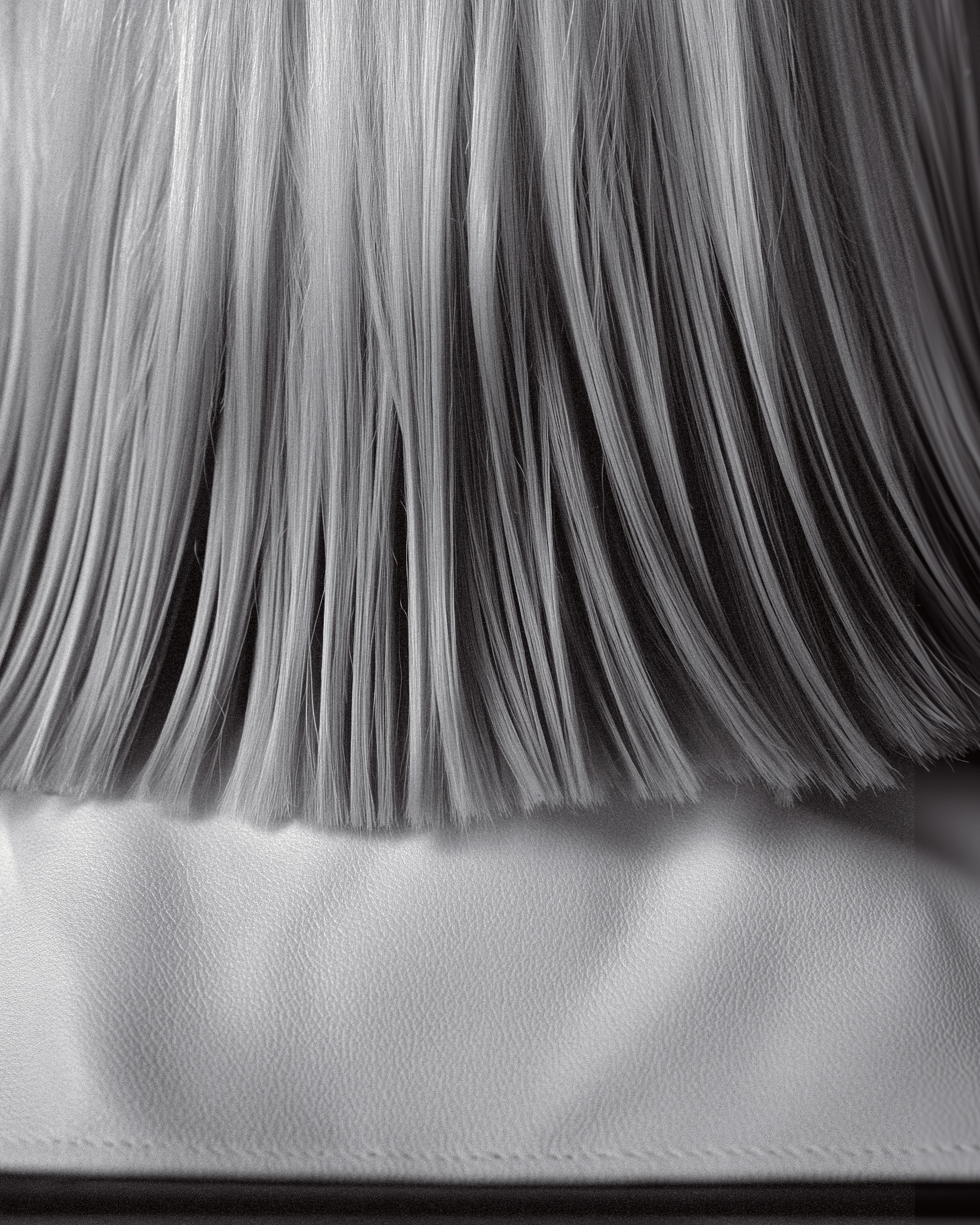 Black-and-white close-up of straight hair strands creating a soft flowing texture.